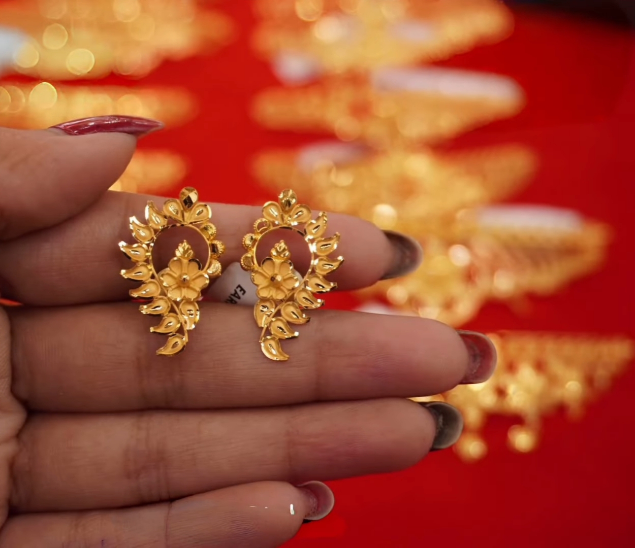 The earring design looks like a peacock's wing.